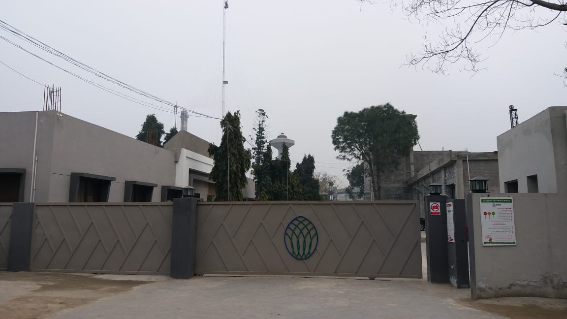Factory entrance gate with the Shahzad Textile emblem